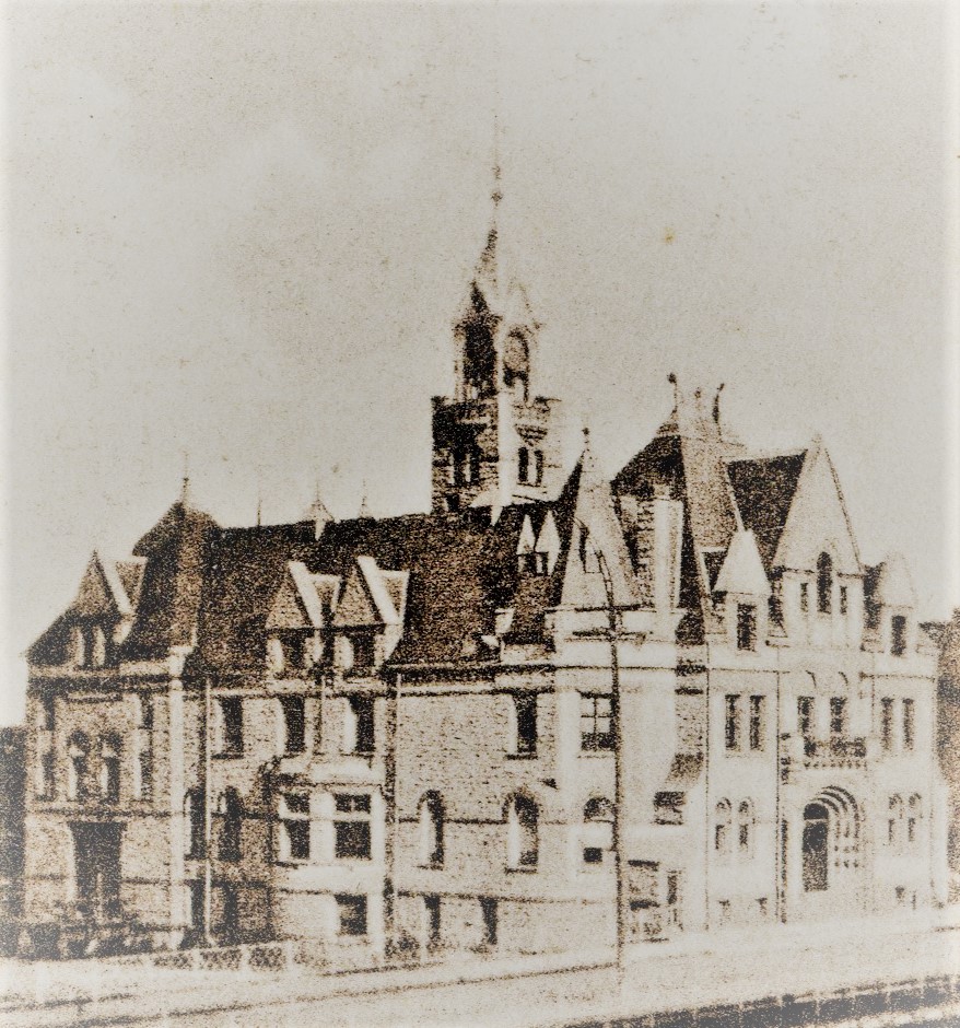 Mini post card of Town Hall, Carleton Place, Ontario. The picture is taken before the town hall got its clock. The bridge can be seen. Caption at the top of the card reads "Town Hall, Carleton Place, Ont."