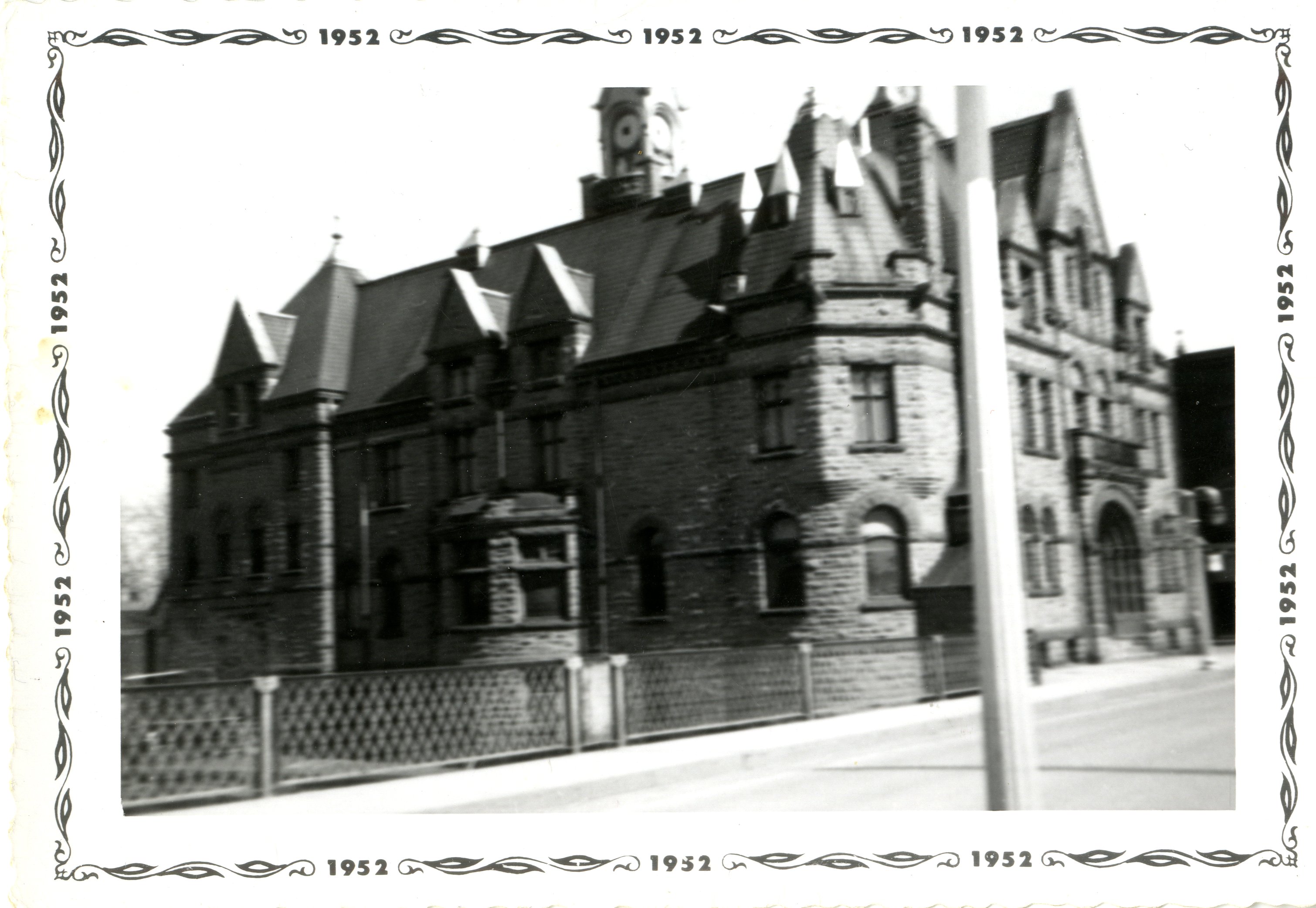 Black and white photograph of Town Hall, Carleton Place. On reverse: "Town Hall Carleton Place H School Girls & boys met for volleyball." Photograph has a border with 1952 on it. The edges of the photographic paper are ridged.