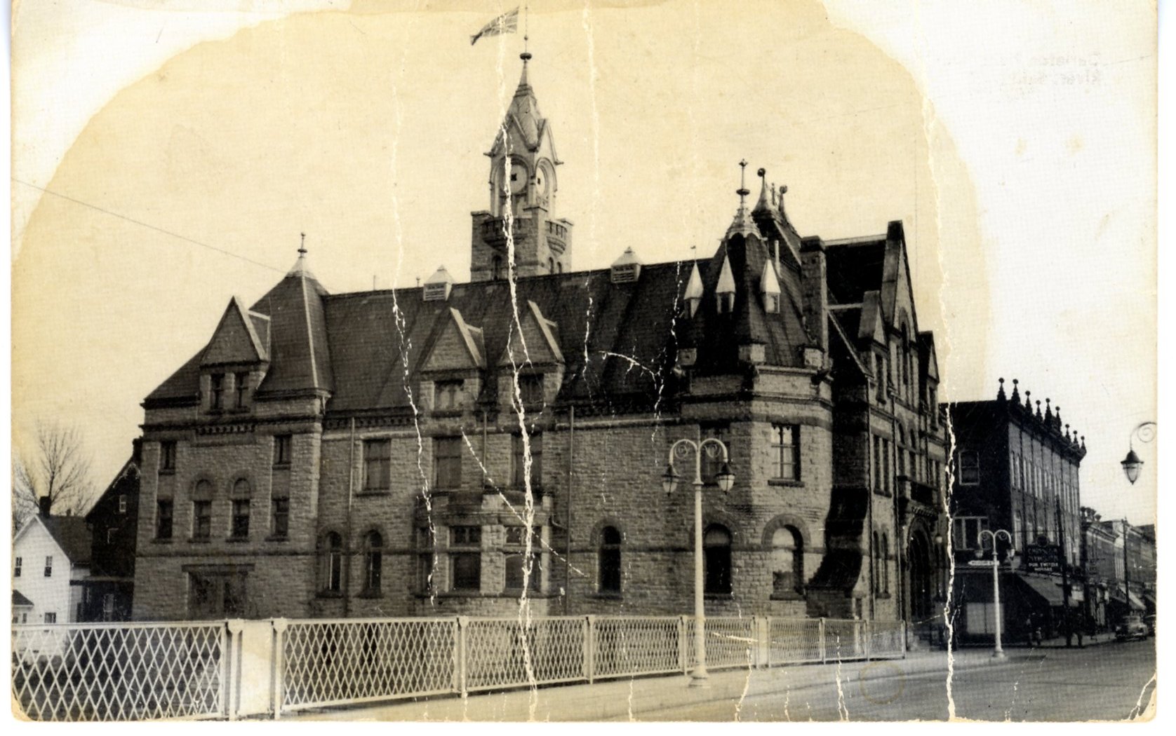 Postcard of a black and white photograph of the Town Hall, taken from the Bridge. Printed on reverse "Carleton Place Town Hall on the banks of the Mississippi River. Built in 1897. Carleton Place, Ontario, Canada"