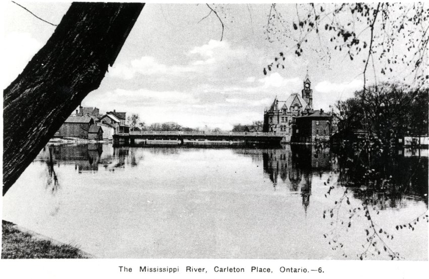 Black and white postcard of the "Mississippi River, Carleton Place, Ontario. -6" featuring the Town Hall and the bridge. No writing on postcard. On reverse: "Post Card / Photogelatine Engraving Company, Co. Limited, Ottawa". Part of set 9, 2005.77.2 - 2005.77.10.