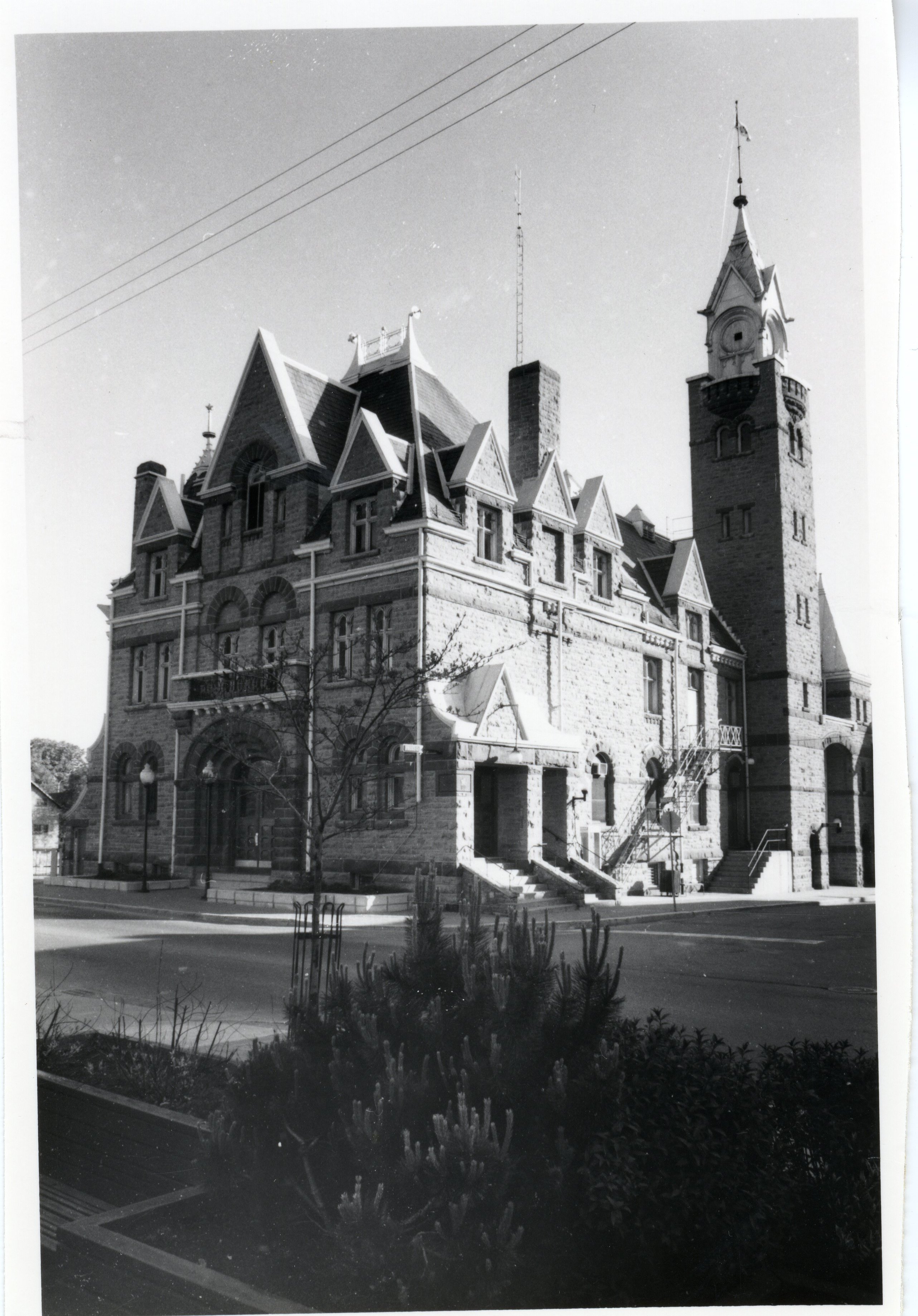 Photograph of the Carleton Place Town Hall, taken from what looks like the parking lot across from the Blossom Shop. Part of a lot of black and white photographs of the East side of Bridge Street around the 1980's.